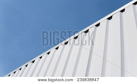 Metal White Sheet For Industrial Building And Construction On Blue Sky Background. Roof Sheet Metal 
