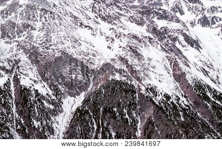 Winter Alpine Background. The Mountainous Terrain In The Snow. Seascape In A Cloudy Day