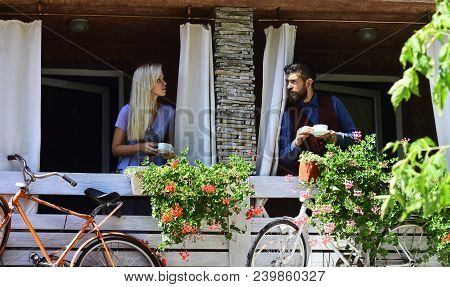 Couple In Love Holds Cups Of Coffee Outside. Lunch Time And Romance Concept. Girl With Blond Hair An