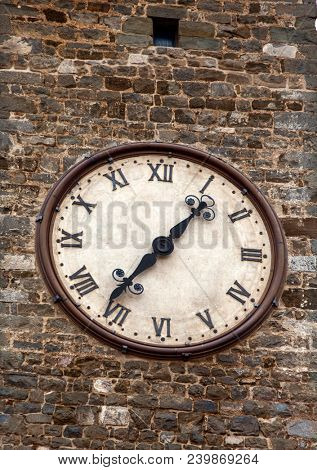 Old clock on birck wall