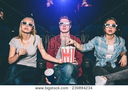 Interestd People Are Watching Movie In Cinema. Thay Are Sitting And Looking Straight Through Special