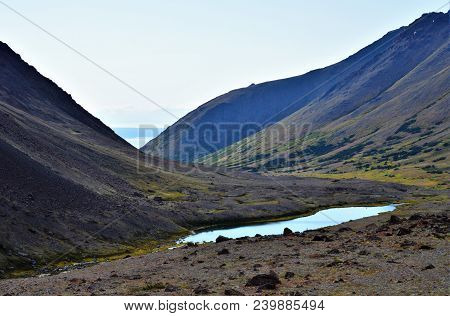 Chugach National Forest Above Anchorage, Alaska.  Landscape
Of Mountains And Creek Running To The Oc