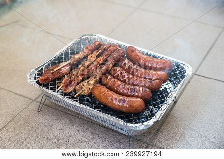 Meat And Sosages Baked On The Barbecue On The Balcony
