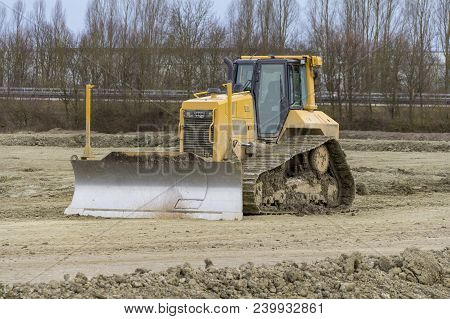 Yellow Bulldozer At A Loamy Construction Site