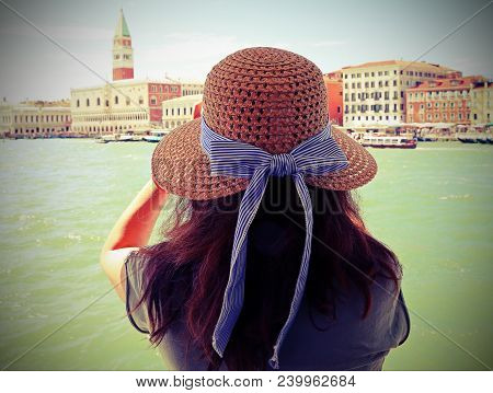 Young Woman With Brown Hair And A Large Straw Hat And The Great Bell Tower In Venice  With Vintage E