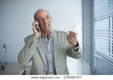 Very Anrgy Senior Busnessman Calling On Phone