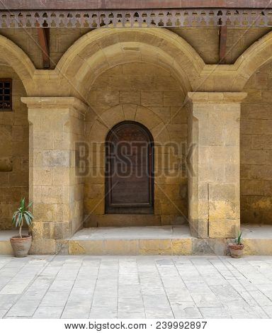 Wooden Decorated Door Framed By Arched Bricks Stone Wall At Caravansary (wikala) Of Bazaraa, Suited 