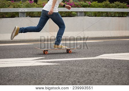 One Young  Woman Skateboarder Sakteboarding On Highway