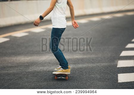 One Young Woman Skateboarder Sakteboarding On Highway