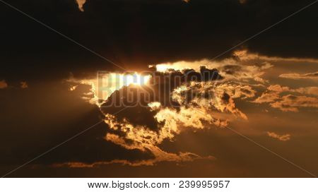 Evening Sun Rays Break Through The Clouds