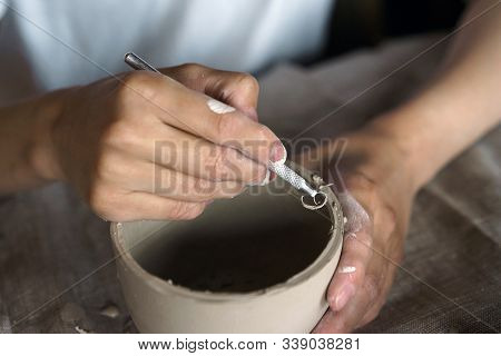 Female Hands Hold A Bowl For Casting Clay Products.