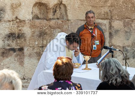 Ramla, Israel, December 07, 2019 : Priest Makes Communion At Collective Prayer On The Ruins Of A Byz