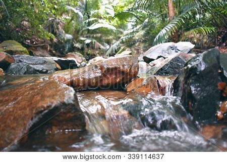 Water Coming Down From The Middle Of The Rocks