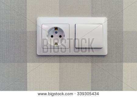 Socket And Switch White On The Background Of Paper Wallpaper On The Wall. Background-vertical And Ho
