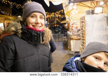 Young Happy Woman With Her Son At Christmas Market