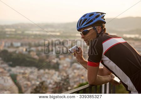 Adventure Male Vloger Using Action Camera Outdoor. A Male Cyclist Blogger Shoots Video On An Action 