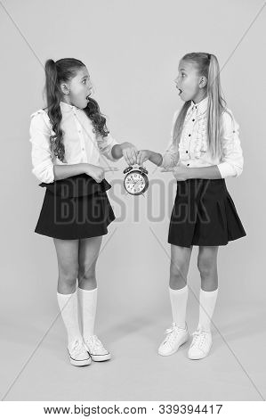 Schoolgirls And Alarm Clock. Children School Pupils. Knowledge Day. School Time. Surprised Shocked K