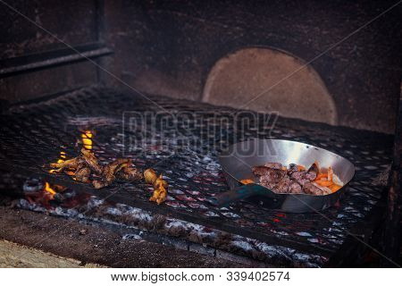 Cooking Traditional Chicken Feet And Meet Sausage On A Coal Grill In South African Reastaurant