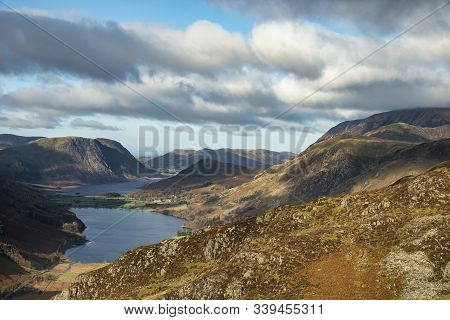 Epic Autumn Fall Landscape Of Buttermere And Crummock Water Surrounded By Mountain Peaks In Lake Dis