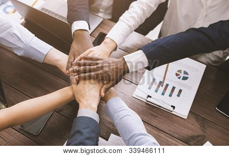 Business Collaboration. Top View On Diverse Corporate Team Hands Stacked Together In Office, Top Vie