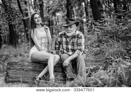 Person With Purported Magical Abilities. Pretty Woman And Senior Freak Grandpa. Woodman Magician Con