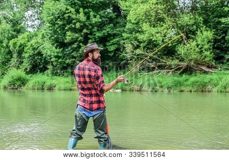 Keep Calm And Fish On. Mature Man Fly Fishing. Man Catching Fish. Fisherman With Fishing Rod. Hobby 