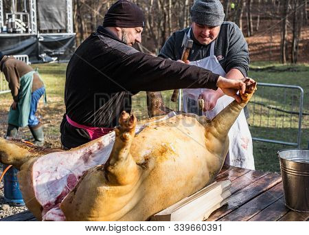 Butchers Slaughtering A Pig