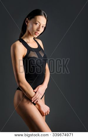Thin Yoga Girl With Oriental Facial Features Shows Pose