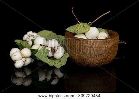 Lot Of Whole White Snowberry In Bamboo Bowl Isolated On Black Glass