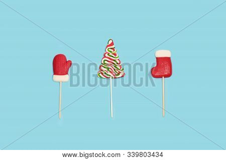 Green Candy Christmas Tree And Ohter Candies On Light Blue Background.