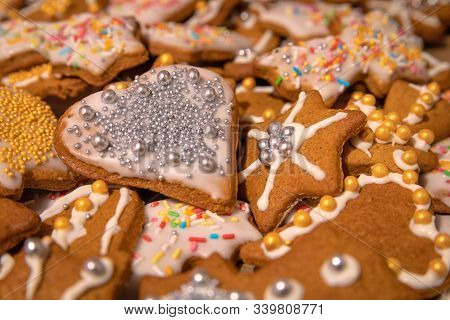 Many Colorful Handmade Gingerbread Cookies Baked And Decorated For Christmas Holidays. Silver And Go