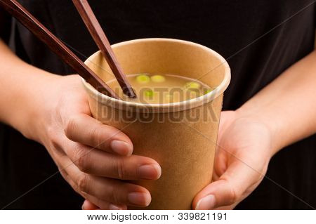 Woman Eating On The Go. Miso Soup In Takeaway Cup. Traditional Asian Cousine.