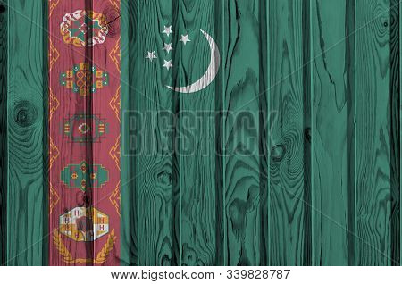 Turkmenistan Flag Depicted In Bright Paint Colors On Old Wooden Wall. Textured Banner On Rough Backg