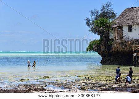 Pingwe, Zanzibar - October 6, 2019: Local Children Play Nearby The Rock Restaurant. It Is World-famo