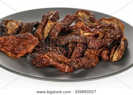 Lot Of Whole Dried Red Tomato Piece On Gray Ceramic Plate Isolated On White Background