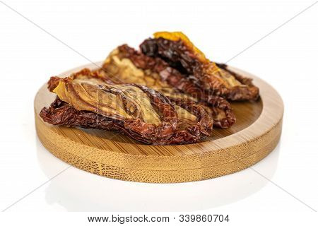 Lot Of Whole Dried Red Tomato Piece On Round Bamboo Coaster Isolated On White Background