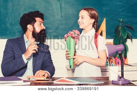 Back To School. Happy Teachers Day. Teachers Day. Daugghter And Father With Flowers. Flower Present 