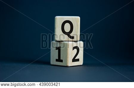 From 1st To 2nd Quarter Symbol. Turned Wooden Cubes And Changed Words 'q1' To 'q2'. Beautiful Grey T