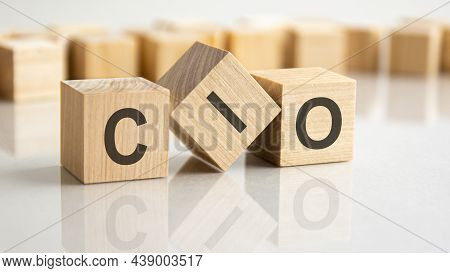 Three Wooden Blocks With The Letters Cio On The Bright Surface Of A Gray Table, Business Concept