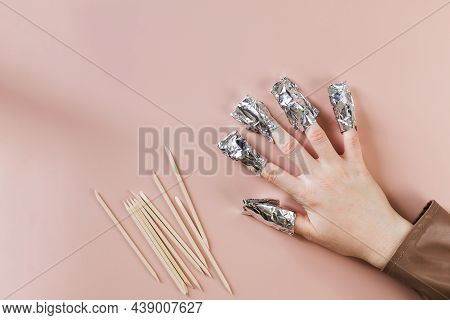 The Process Of Removing Gel Polish From Nails. Nails Are Wrapped In Falga On A Pink Background. Copy