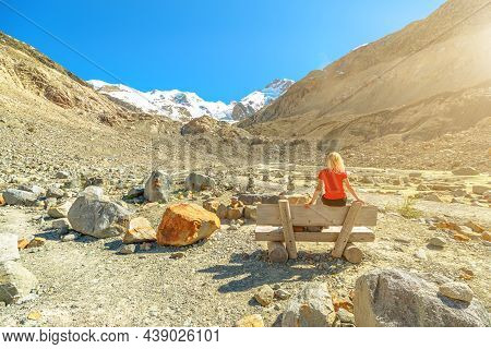 Backside Of Girl On The Bench Of Lookout Of Morteratsch Melting Glacier In Switzerland. Biggest Glac