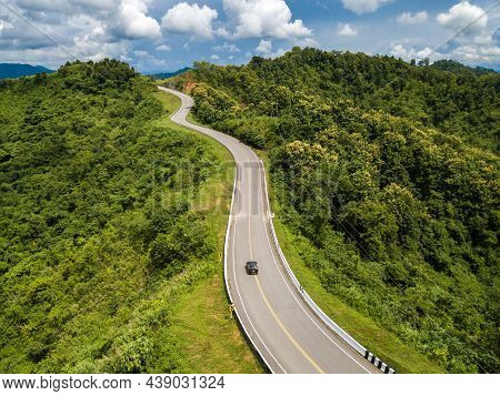 Aerial View Of Car Driving On Beautiful Steep Curved Road (look Like Number 3) On The High Mountain 