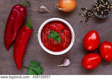 Top View Of Lecho Of Tomatoes And Sweet Paprika With Ingredients On The Table. Lecso National Dish O