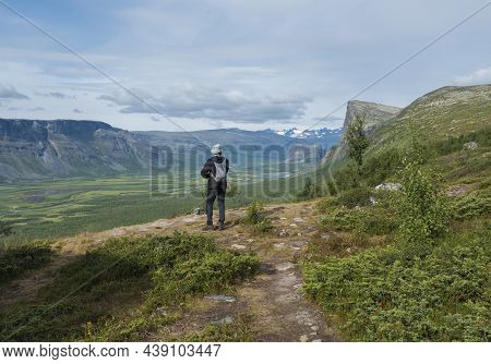 Man Hiker Admiring View On Meandering Glacial Rapadalen River Delta Valley At Sarek National Park, S