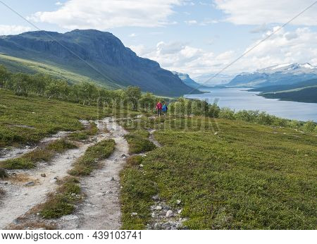 Lapland Landscape With Beautiful River Lulealven, Snow Capped Mountain, Birch Tree And Footpath Of K