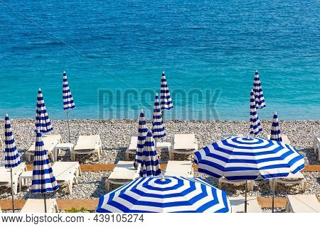 Parasols And Deckchairs On Beach Of Nice In Sunny Summer Day With Blue Sky, Nice, French Riviera, Fr