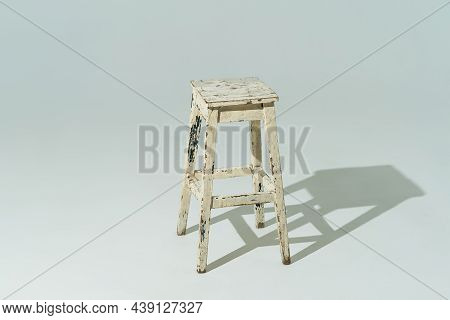 Tall Retro Stool Or Tabouret With Peeling White Paint On White Background. Empty Place.