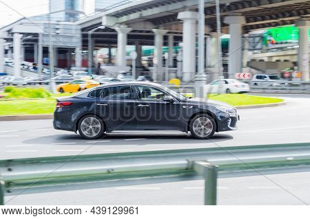 Moscow, Russia - August 2021: Black Kia Optima Tf Car Eighth Generation, Speed Driving On Asphalt Ci