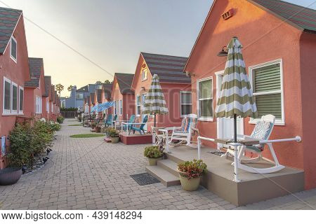Row Of Small Cabins With Coral Pallette Exterior At Oceanside, California