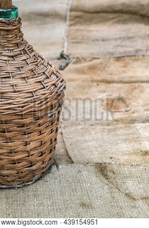 Demijohn And Old Wood Wine Barrel On Jute Sack